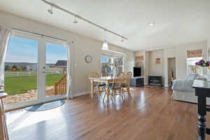 Dining room with track lighting and hardwood / wood-style flooring