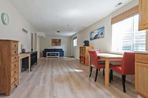 Dining space featuring light wood-type flooring and baseboards