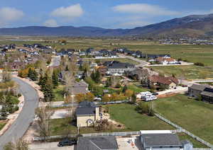 Aerial view of property's location with mountains and nearby suburban area
