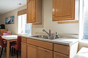 Kitchen with light countertops and wood finish cabinetry