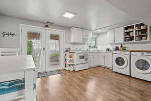 2nd Kitchen featuring walkout basement, white electric stove, french doors, and light wood finished floors