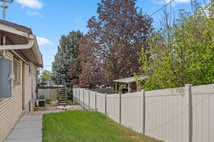 Fenced backyard featuring a patio and stairs