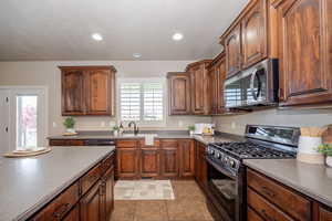 Kitchen with stainless steel appliances & gas-range