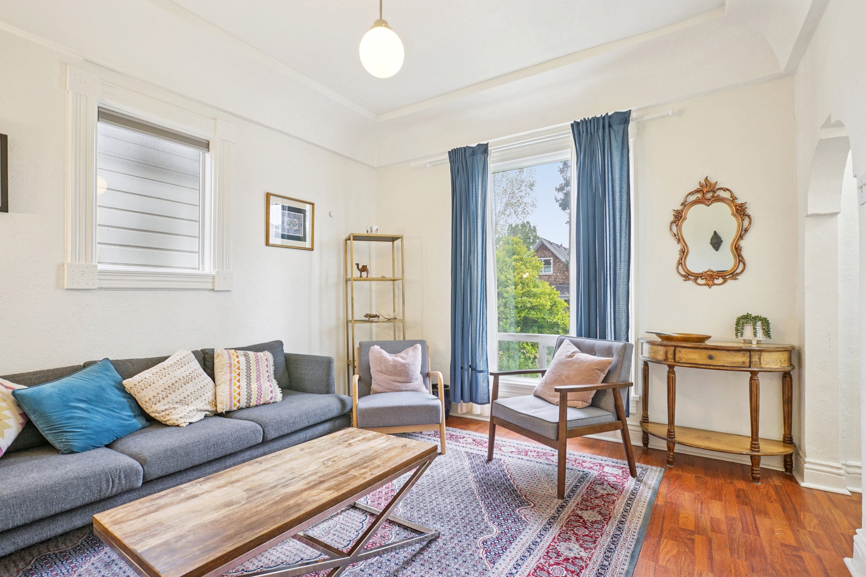 Living area featuring wood finished floors and arched walkways
