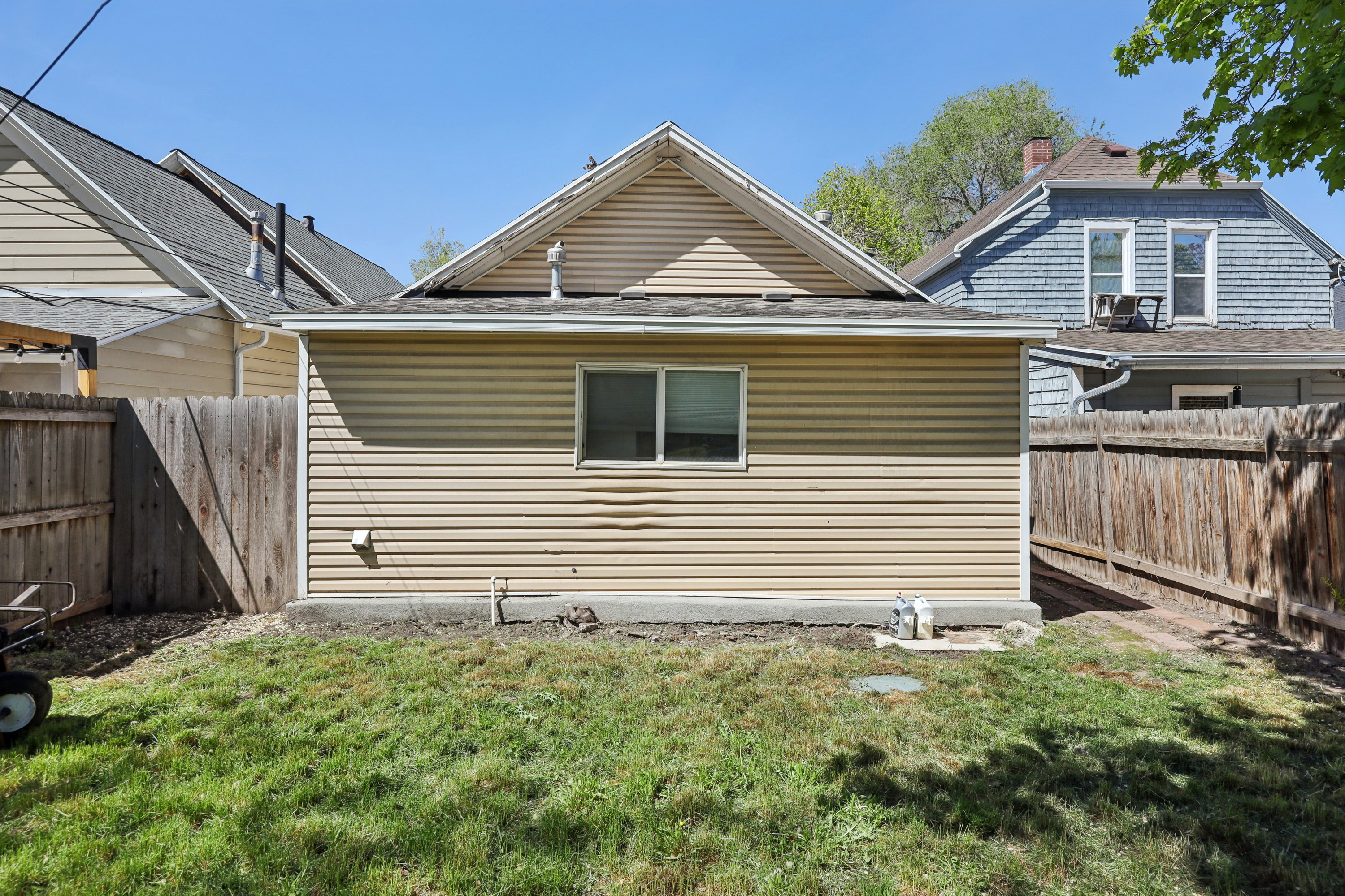 View of home's exterior with a fenced backyard, roof with shingles, and a chimney