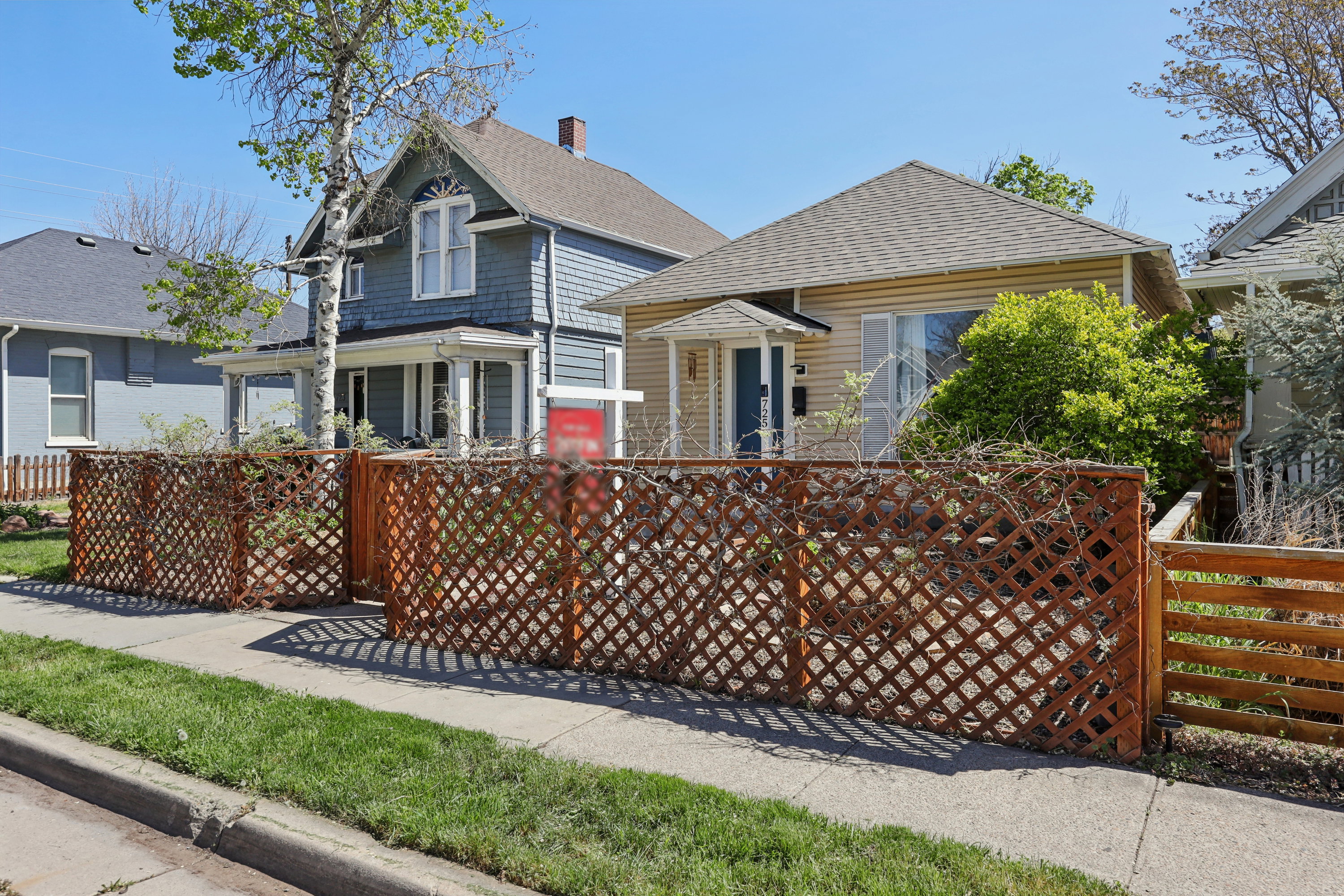 View of front of house featuring a fenced front yard and a shingled roof