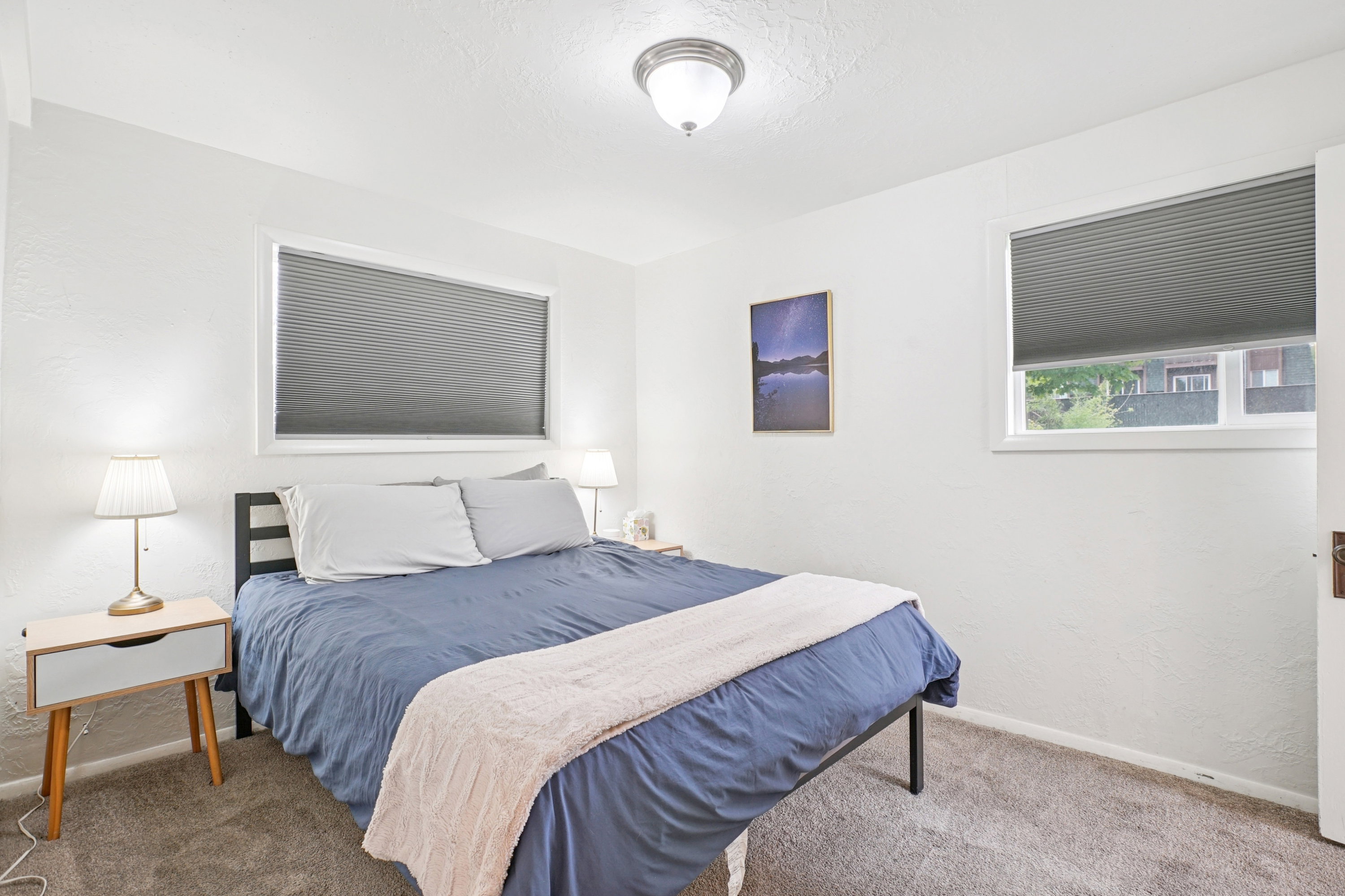 Bedroom featuring a textured wall and carpet floors