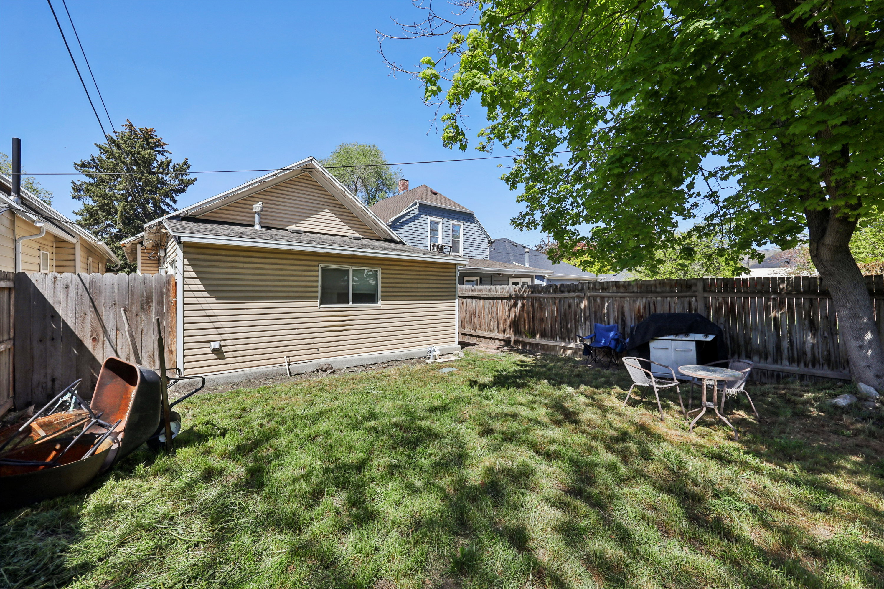 Rear view of house with a fenced backyard