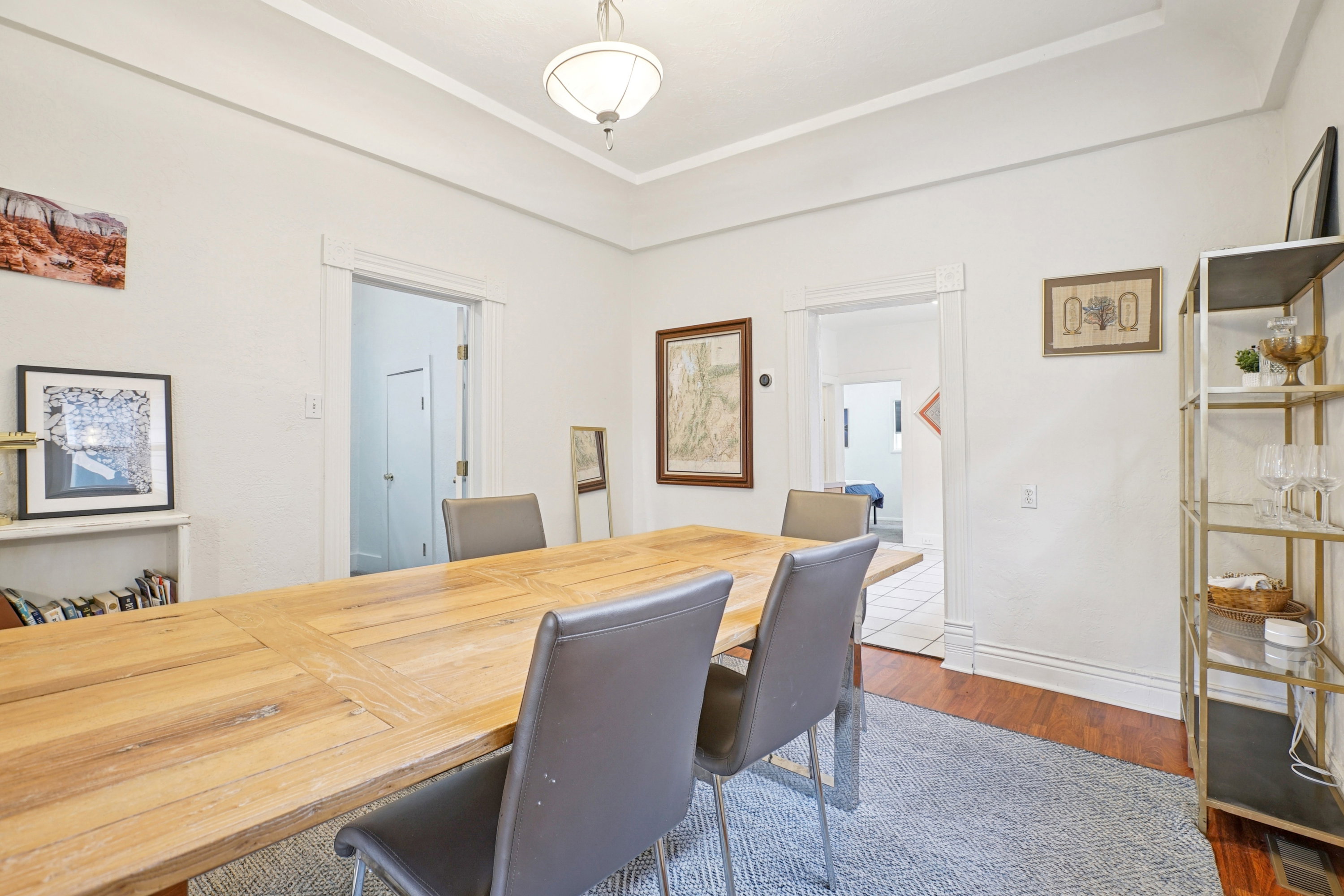Office area featuring dark wood-style flooring and baseboards