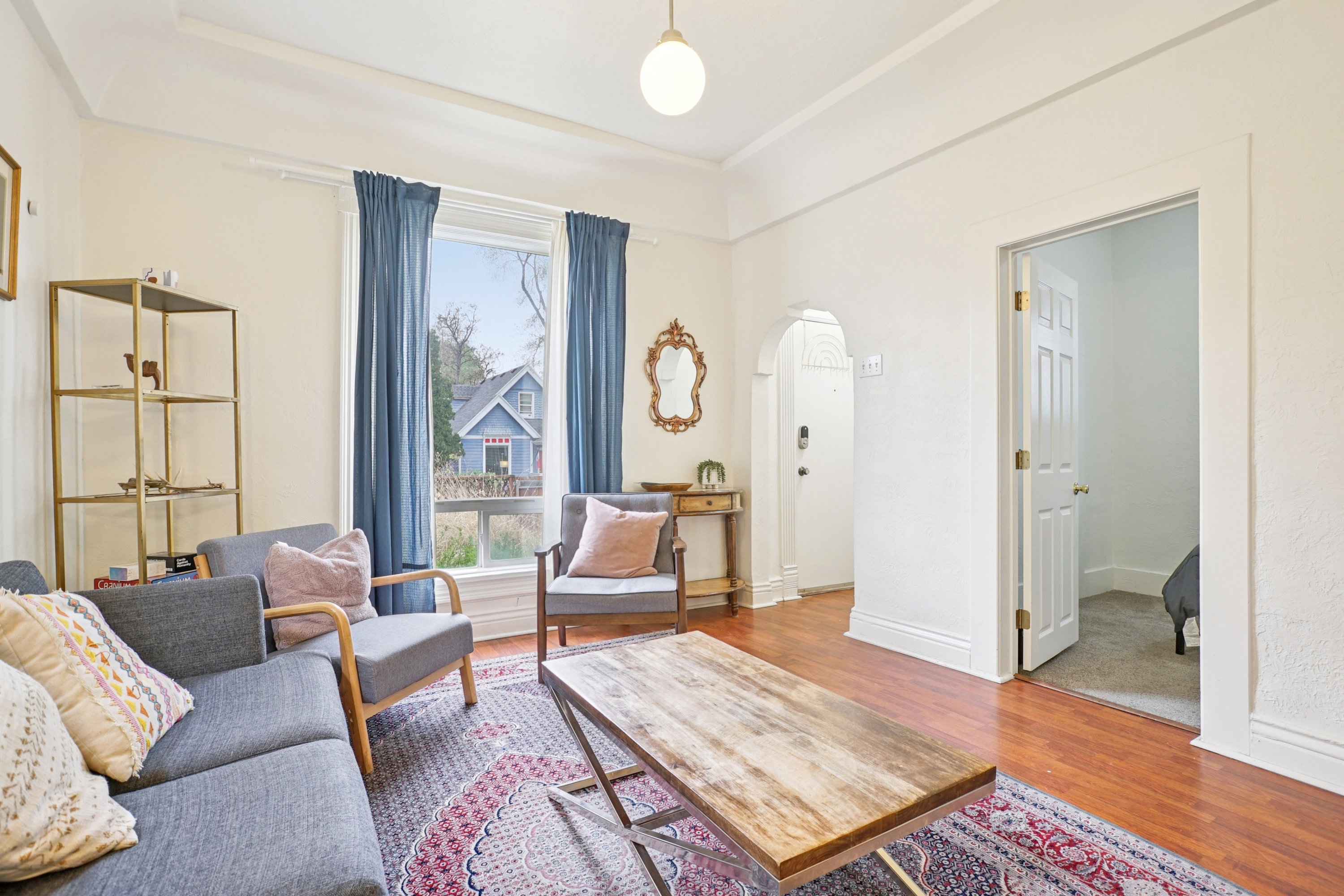 Living room featuring arched walkways and wood finished floors