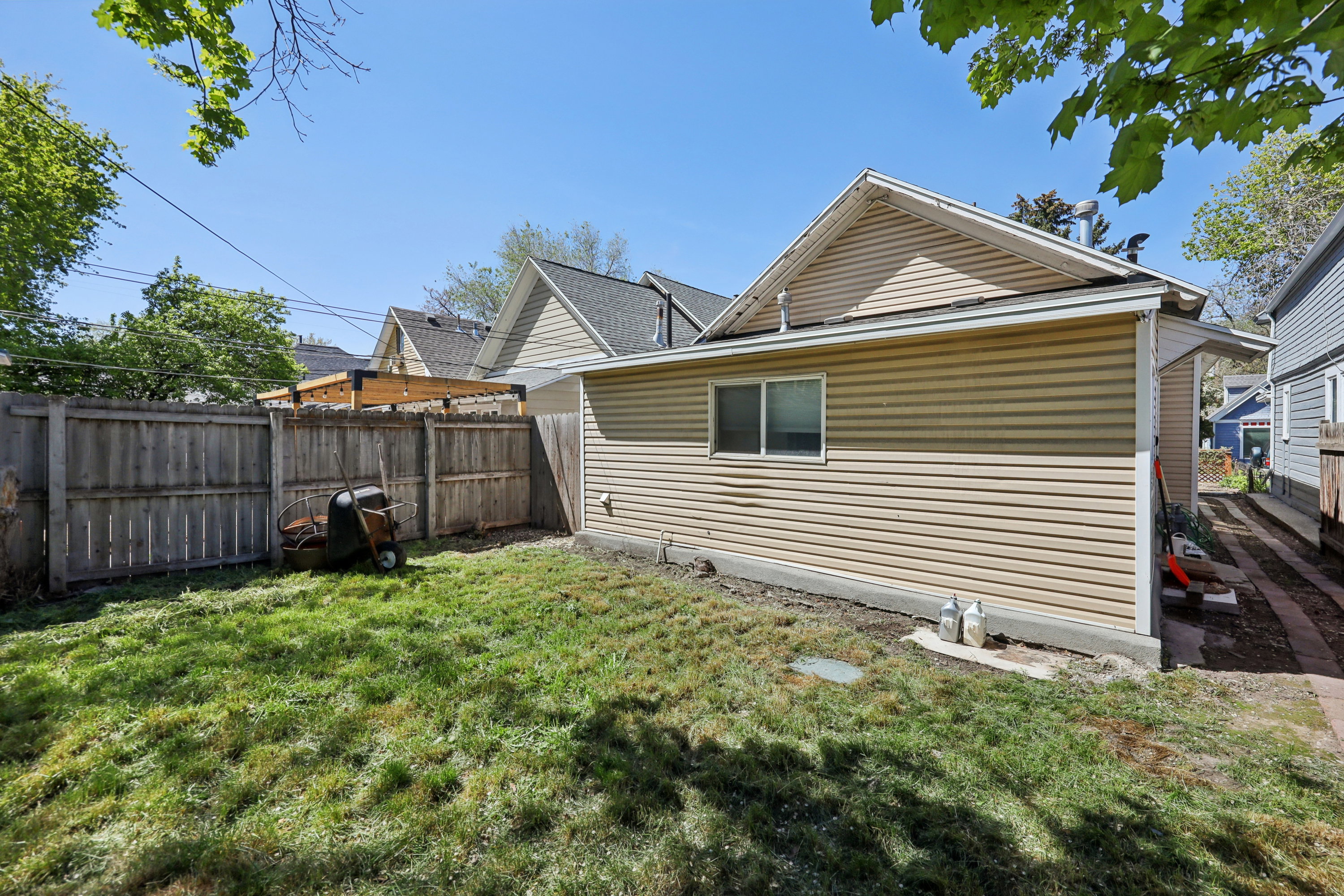 Rear view of house with a fenced backyard