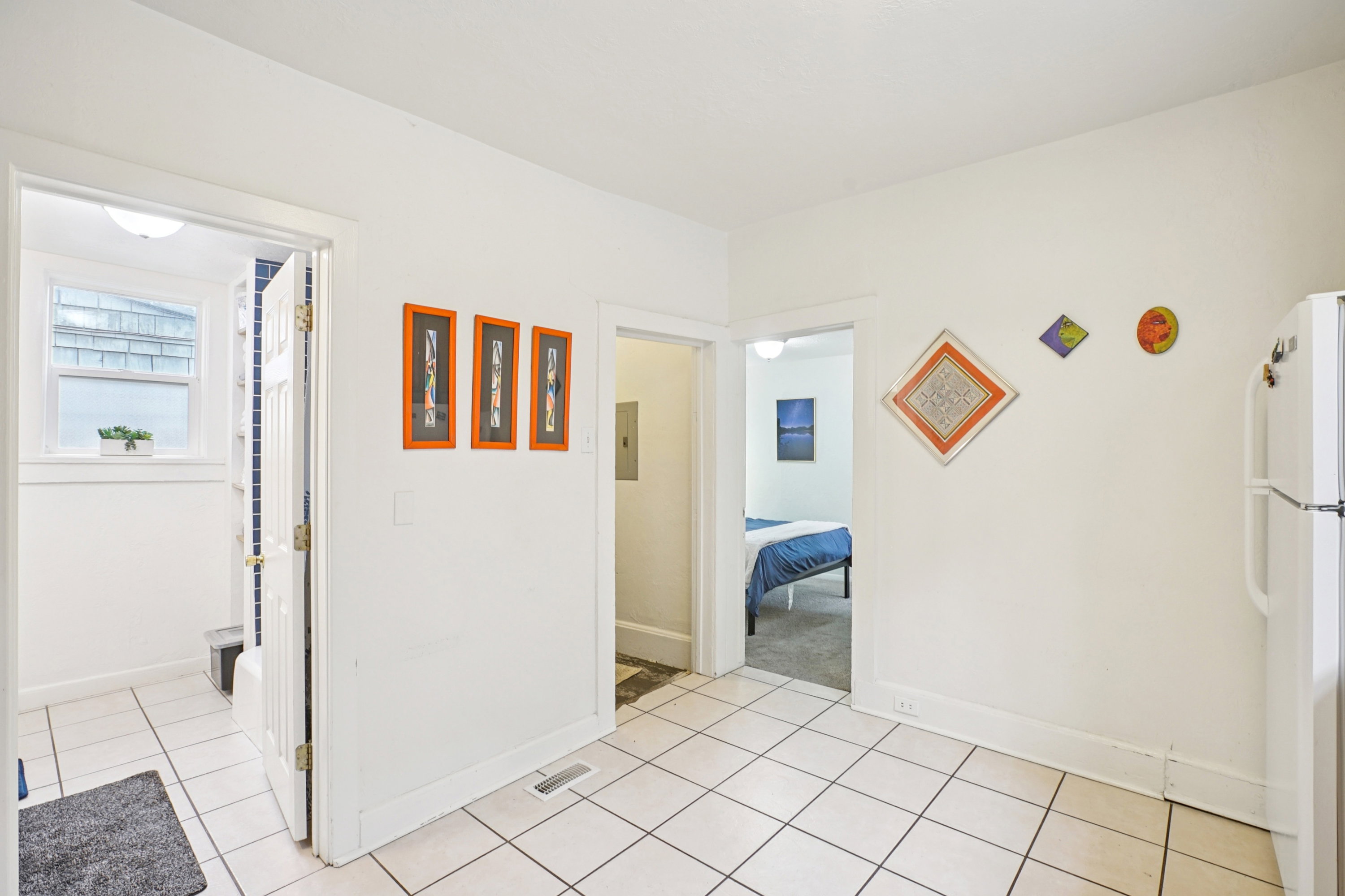 Corridor featuring baseboards and light tile patterned floors