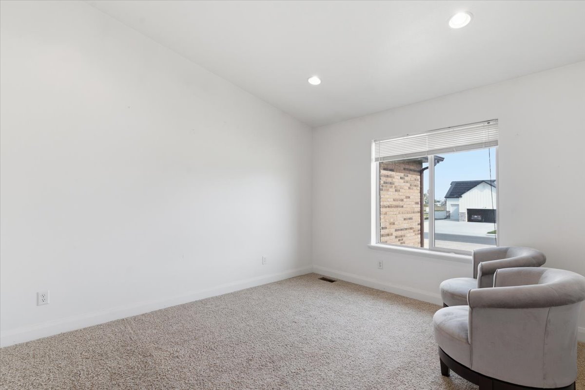 Living area featuring carpet floors and recessed lighting