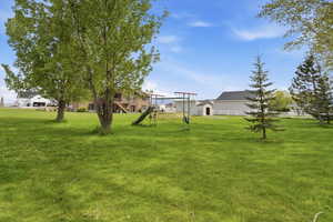 View of green lawn featuring a residential view