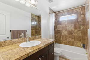 Full bath featuring vanity and shower / bath combo