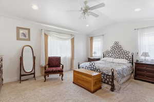 Bedroom with light colored carpet, lofted ceiling, ceiling fan, and recessed lighting