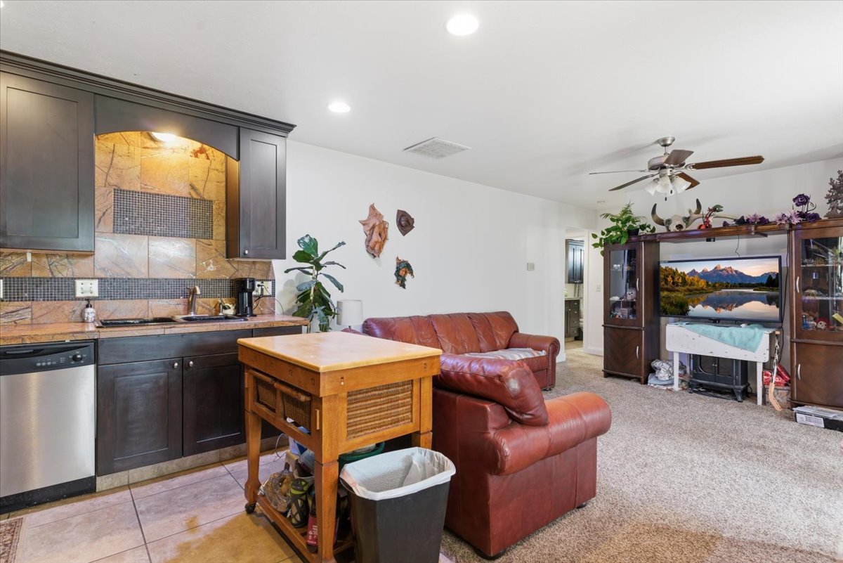 Living area with a ceiling fan and recessed lighting