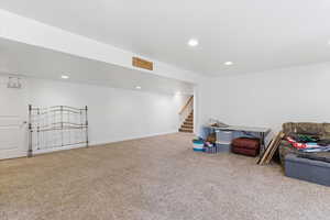 Finished below grade area with carpet floors and recessed lighting