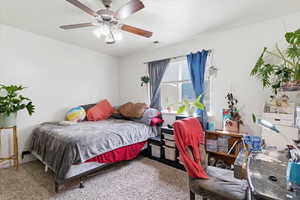 Bedroom featuring ceiling fan and carpet floors