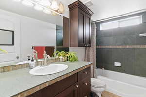 Full bathroom featuring vanity and shower / bath combination with curtain