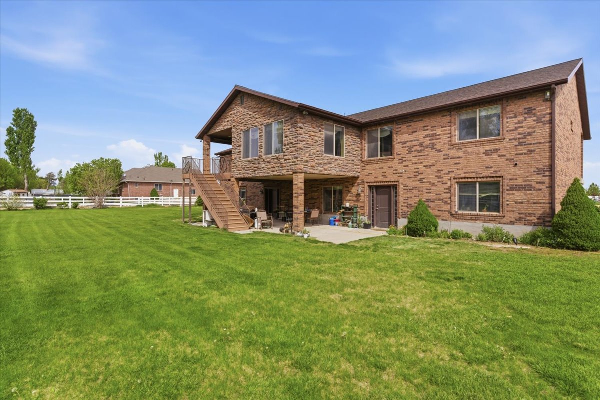 Rear view of property featuring a patio area and brick siding
