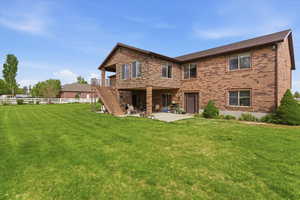 Rear view of property featuring a patio area and brick siding