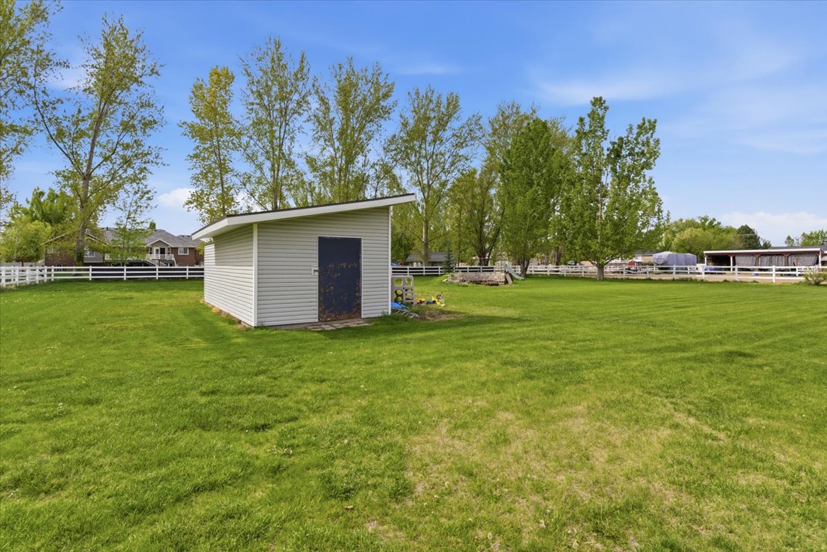 Fenced backyard with a storage unit