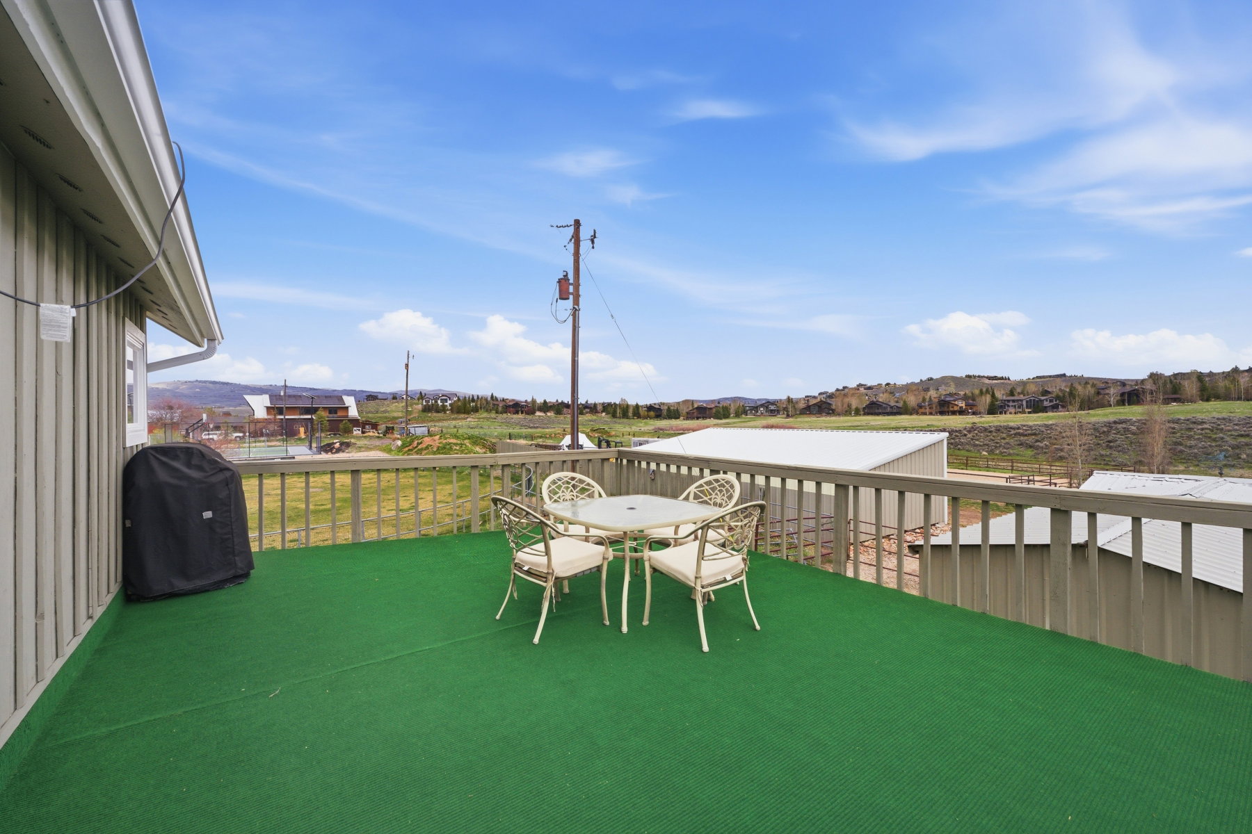 View of patio / terrace featuring outdoor dining space, grilling area, and a residential view