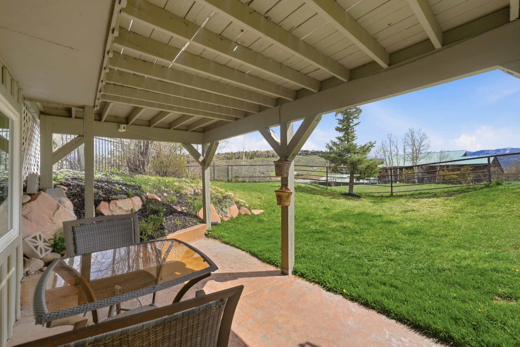 Fenced backyard with outdoor dining space, a patio, and a mountain view