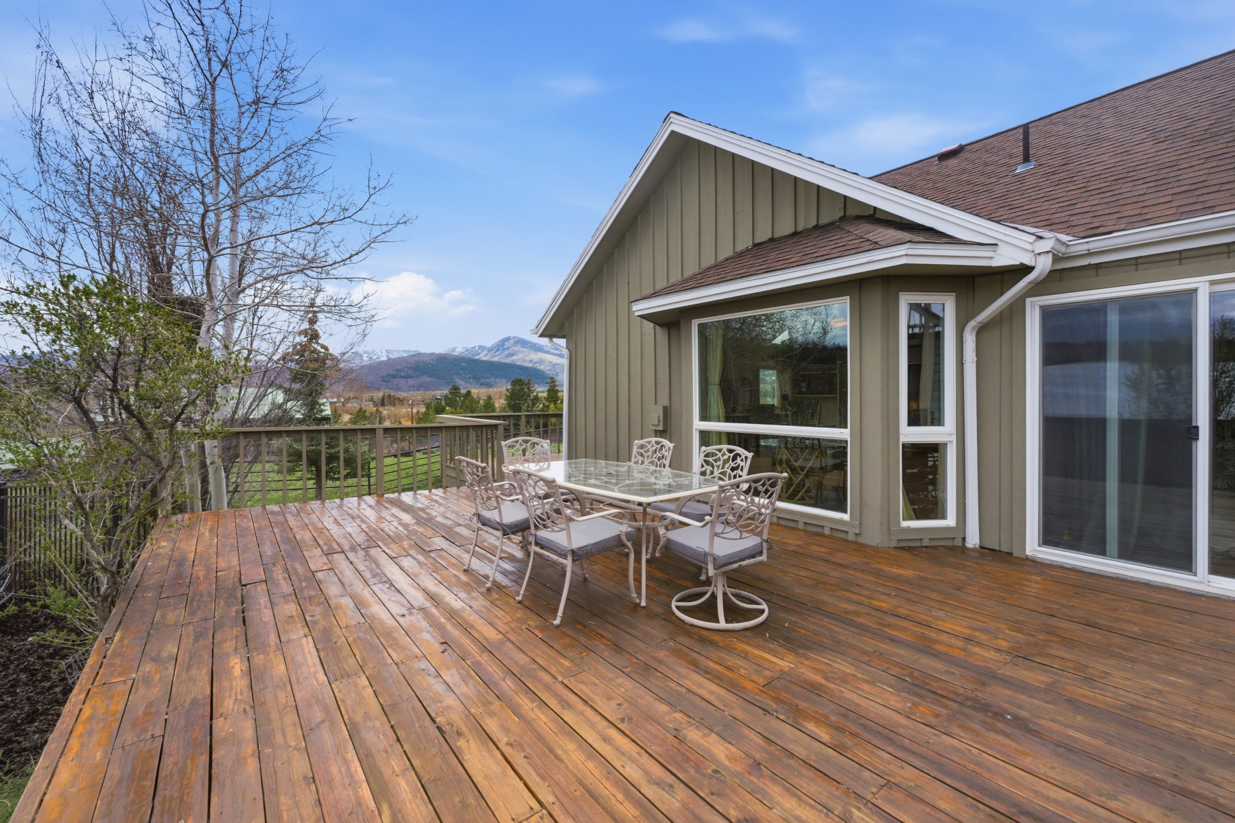 Wooden deck featuring outdoor dining space and a mountain view