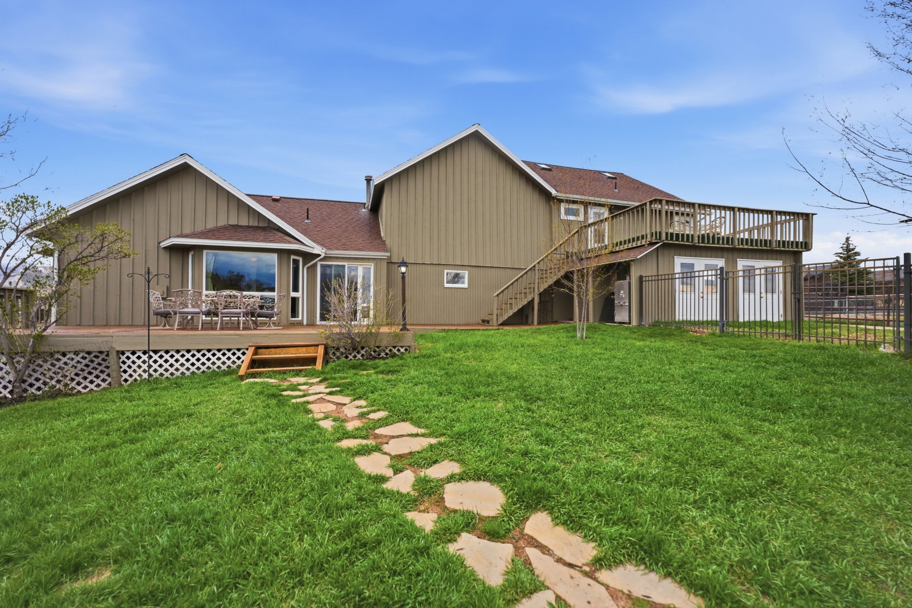 Rear view of property featuring a wooden deck