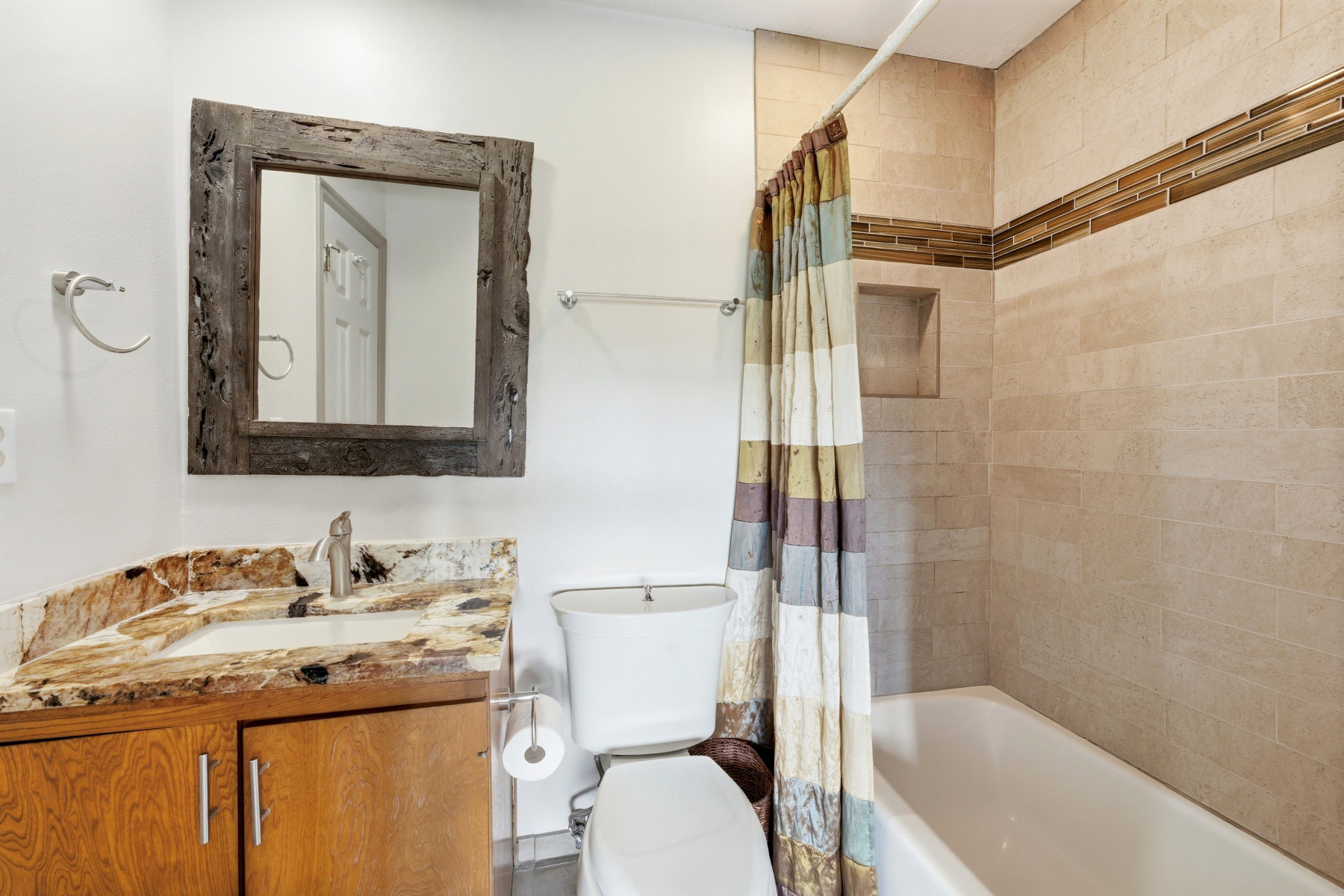Full bath with vanity and shower / bath combination with curtain