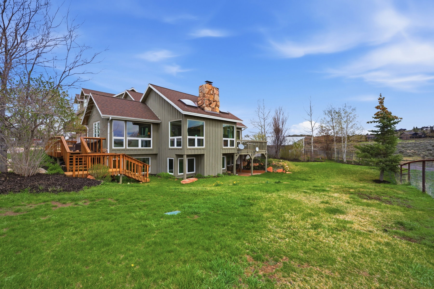 Rear view of property with a wooden deck and a chimney