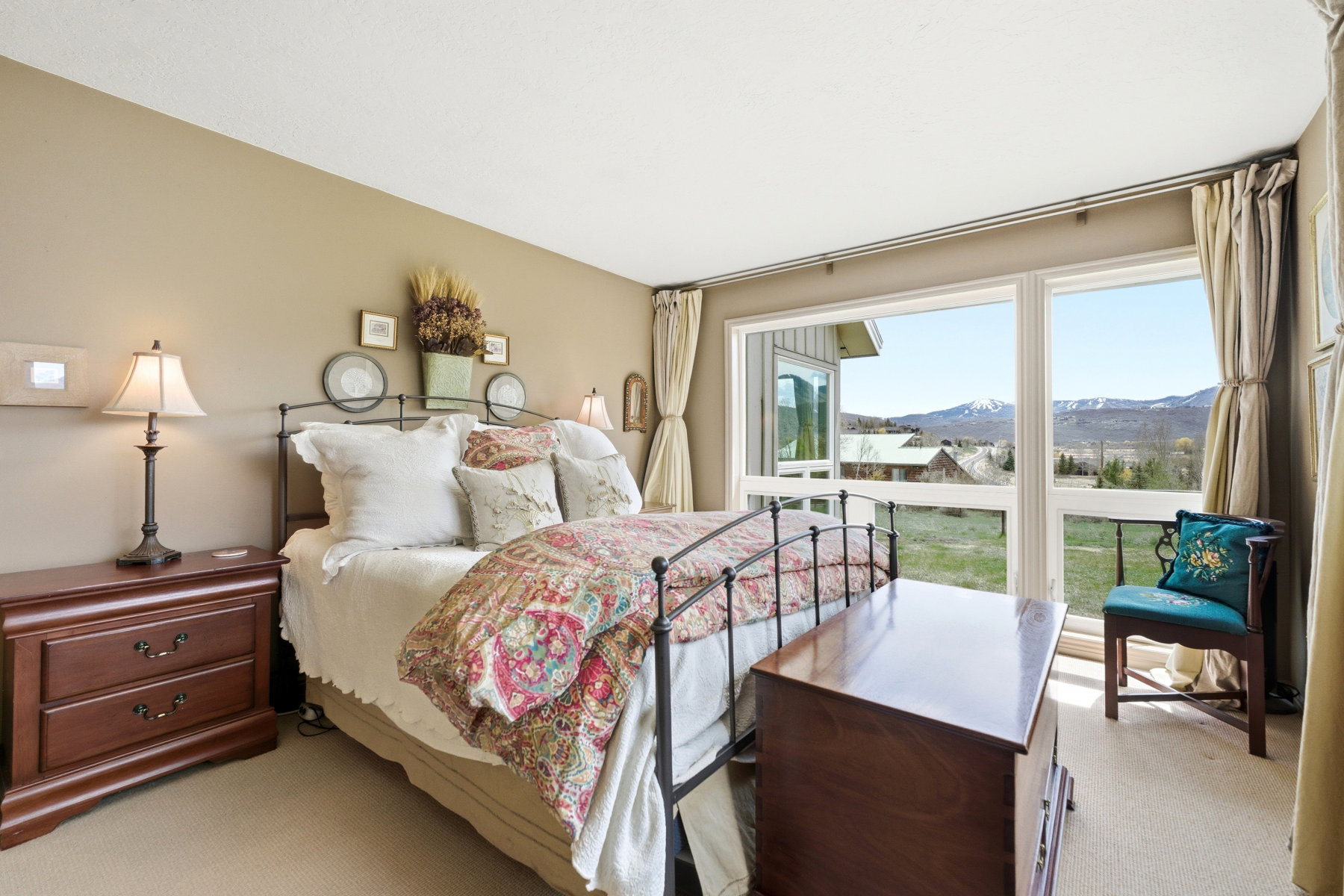 Carpeted bedroom with a mountain view
