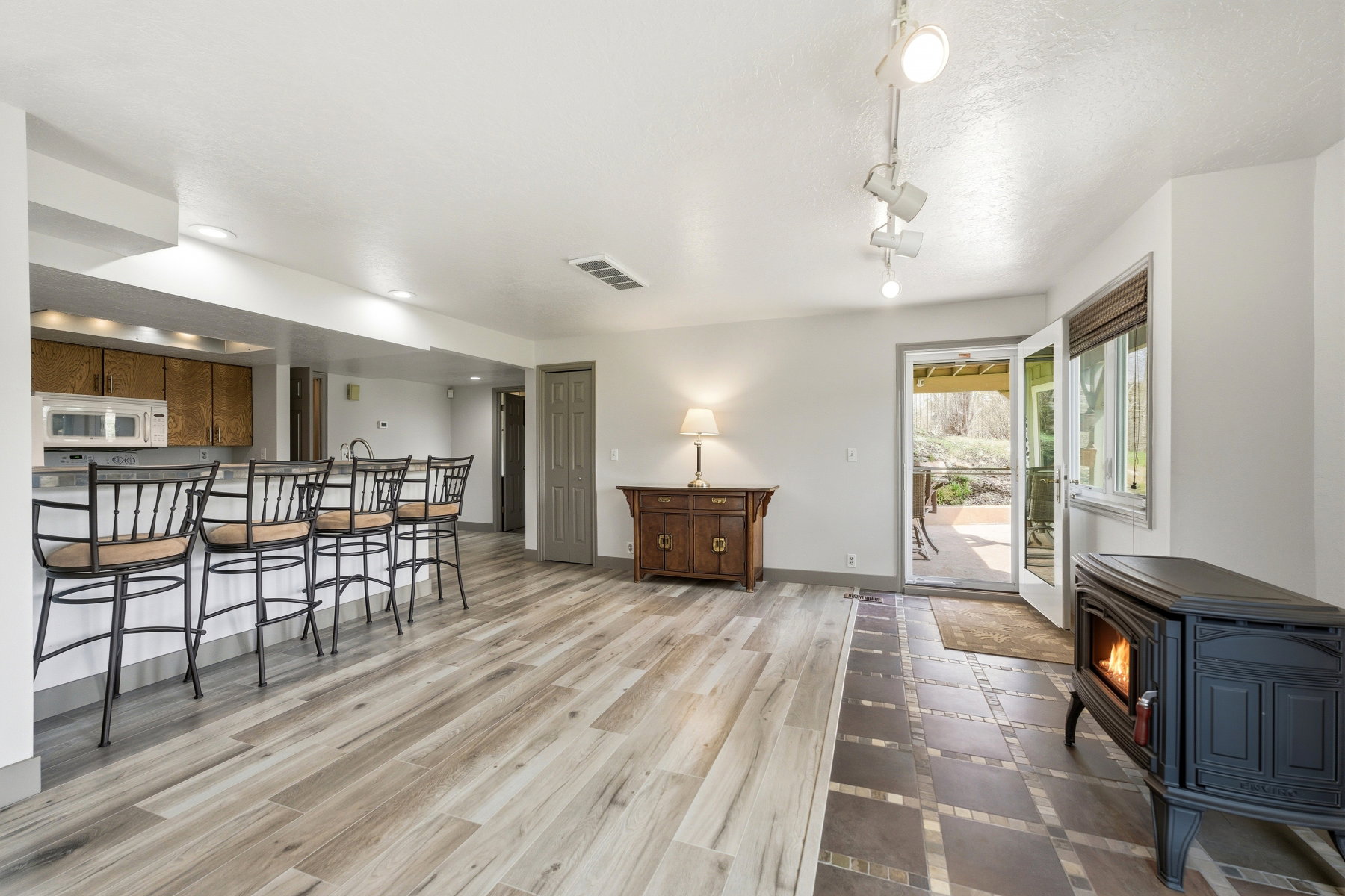 Dining area with light wood finished floors and a wood stove