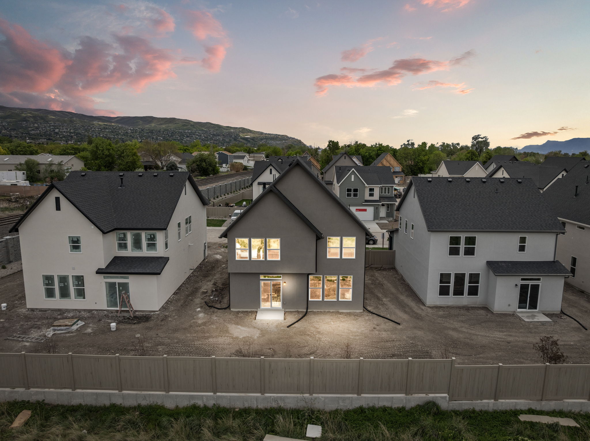 Back of property with a fenced backyard, a residential view, and stucco siding