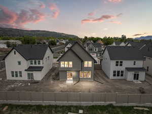 Back of property with a fenced backyard, a residential view, and stucco siding