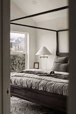 Bedroom featuring lofted ceiling