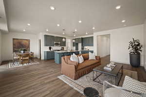 Living area featuring dark wood finished floors and recessed lighting