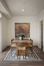 Dining area with baseboards and dark wood-type flooring