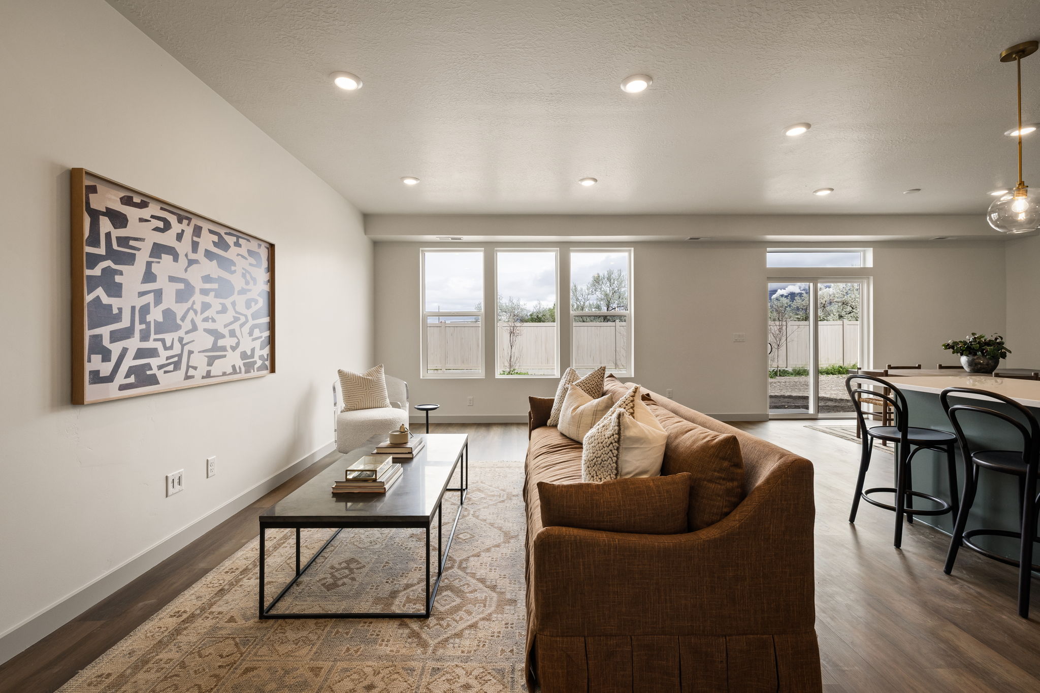Living room featuring dark wood-style floors, recessed lighting, and a textured ceiling