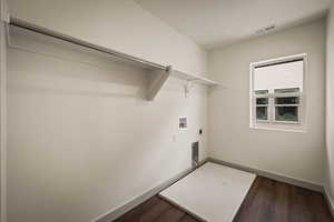 Laundry room featuring dark wood-style flooring, hookup for an electric dryer, and washer hookup