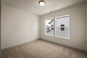 Unfurnished room with light colored carpet and baseboards