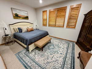 Carpeted bedroom with baseboards