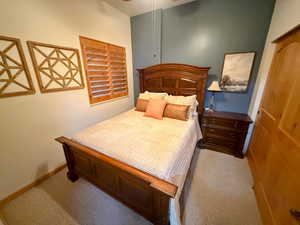 Carpeted bedroom featuring a ceiling fan