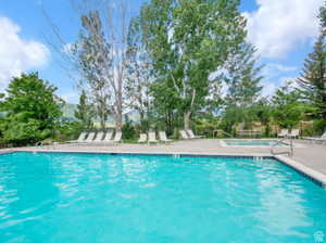 Community pool with a patio