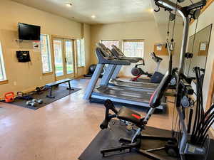 Workout area featuring recessed lighting and french doors