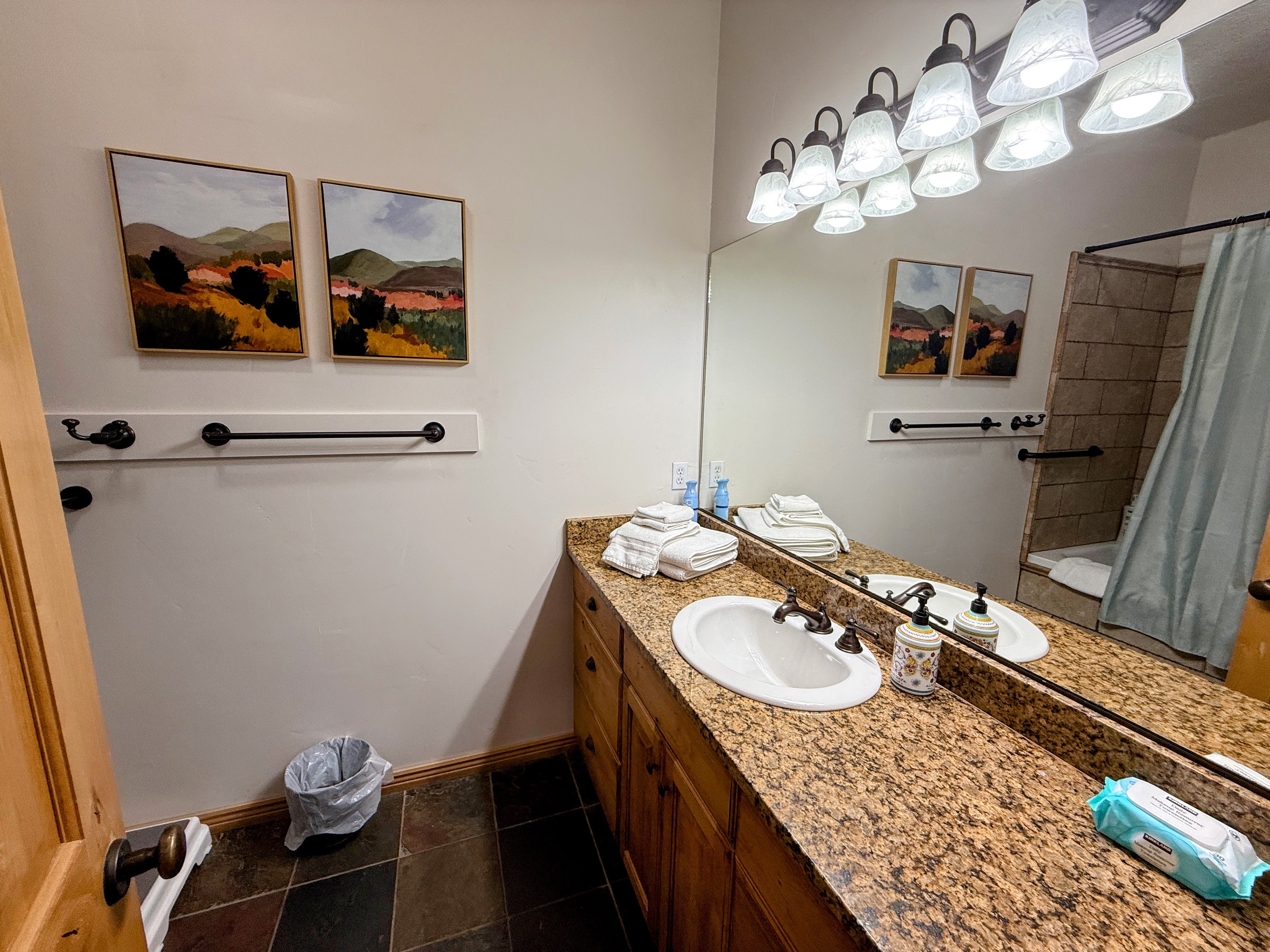 Full bath featuring vanity and baseboards