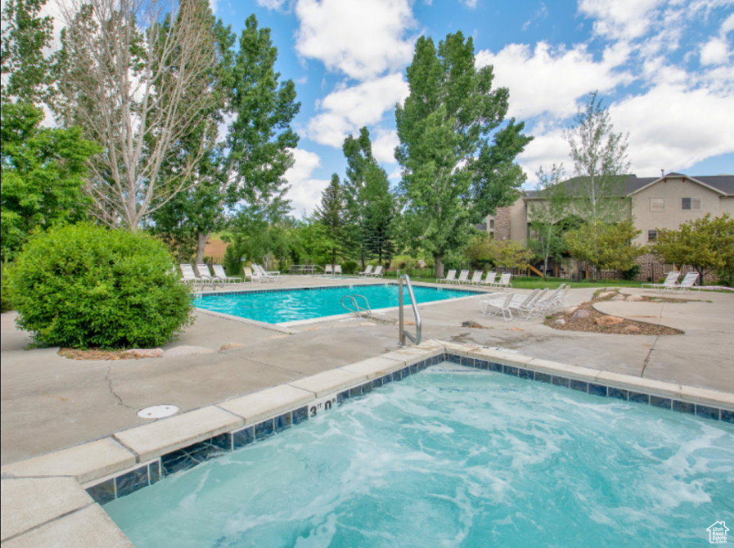 Community pool with a patio