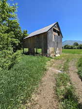 View of outbuilding with a rural view and a mountain view